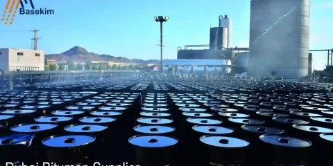 Dubai Bitumen Supplier facility with rows of steel drums ready for export, managed by Basekim for African and global markets.