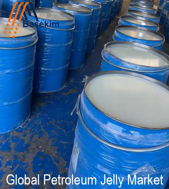 Rows of blue steel drums filled with refined petroleum jelly, ready for global shipment, featuring the Basekim logo on top of the image.