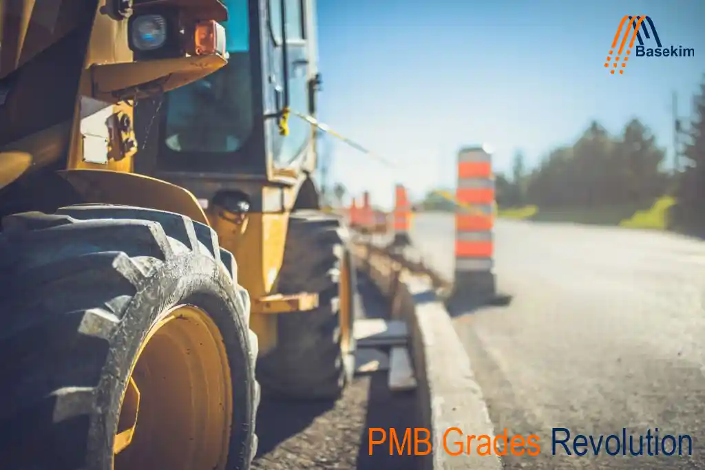 Close-up view of road construction machinery applying advanced Polymer Modified Bitumen (PMB) on a highway under development, with safety barriers and blurred cityscape in the background