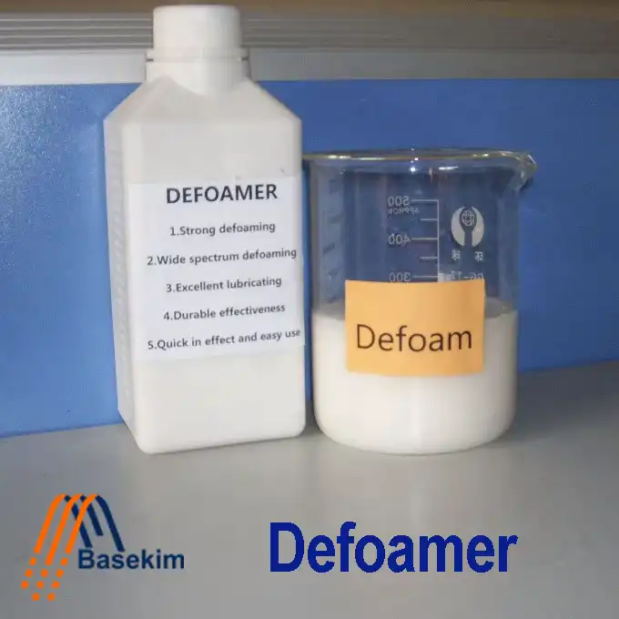 A white bottle labeled "Defoamer" next to a glass beaker containing a white liquid with a label reading "Defoam," representing industrial foam control products supplied by Basekim.